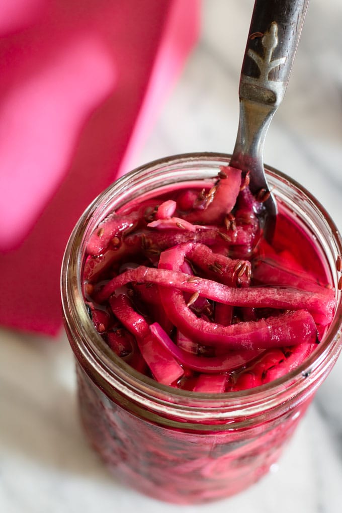 overhead view of pickled red onions in jar