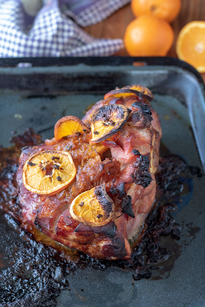 back side of ham with orange slices and cloves