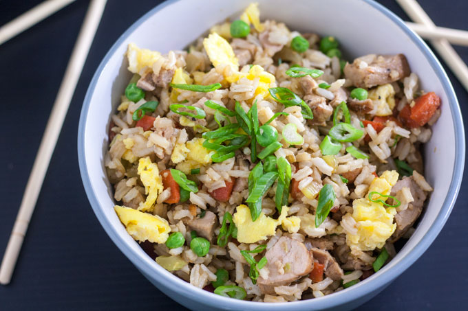 bowl of pork fried rice on black background