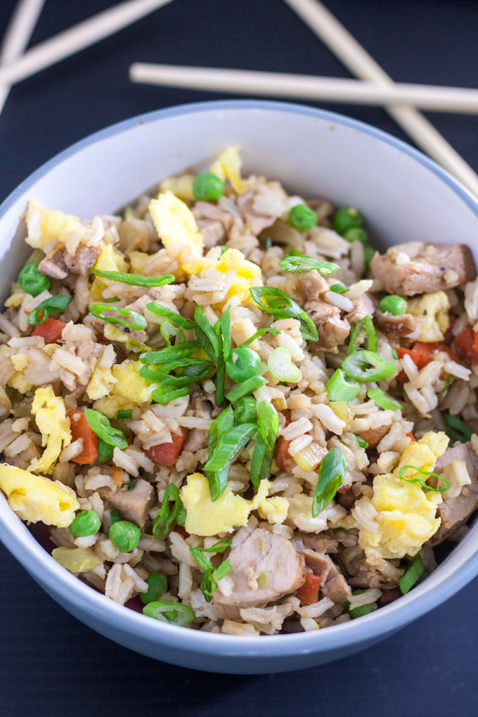 close up of pork fried rice with eggs, peas and carrots