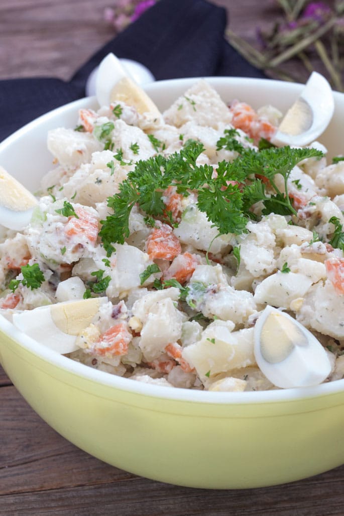 yellow bowl with potato salad topped with egg for July 4th recipe