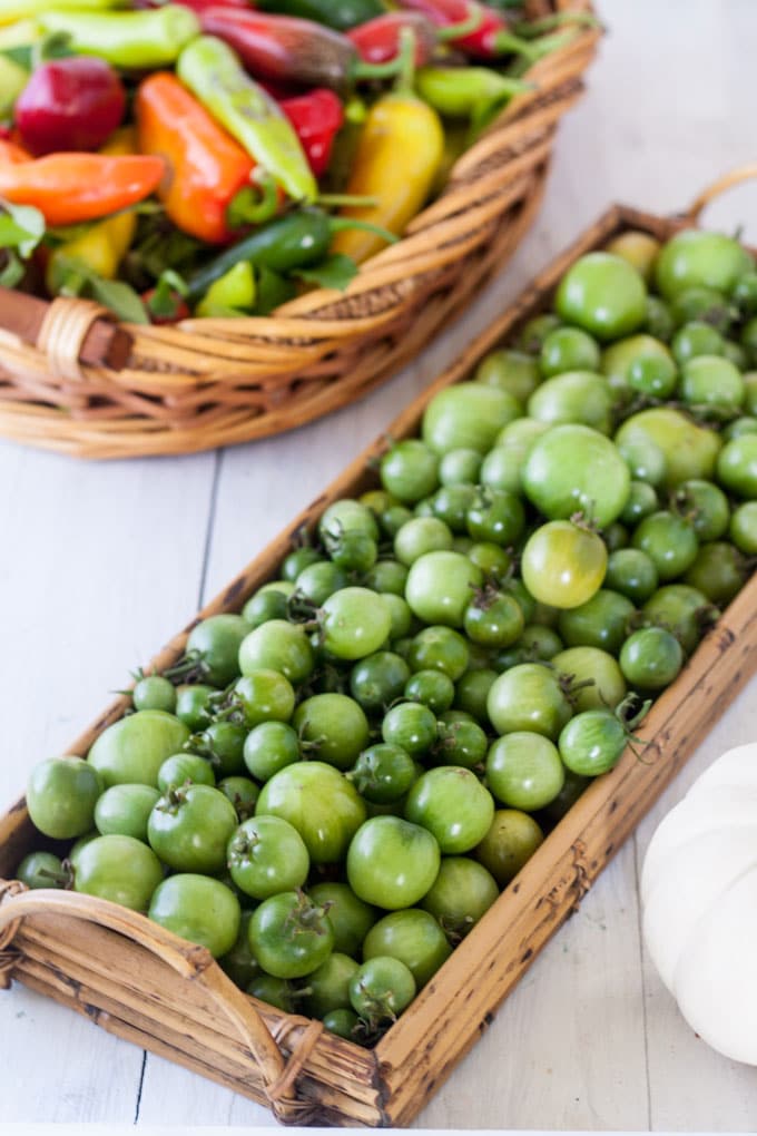 green tomatoes and peppers in baskets