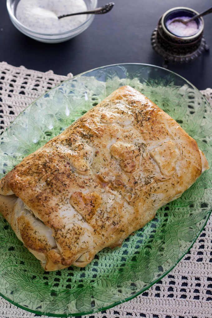 salmon wellington on green plate with antique crotched placemat
