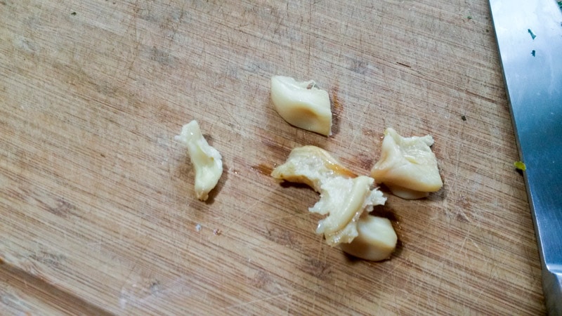 Roasted garlic cloves with skins removed on cutting board.
