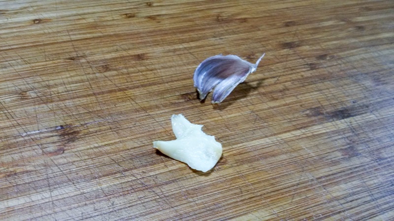 Roasted garlic on wooden cutting board, removed from skin.