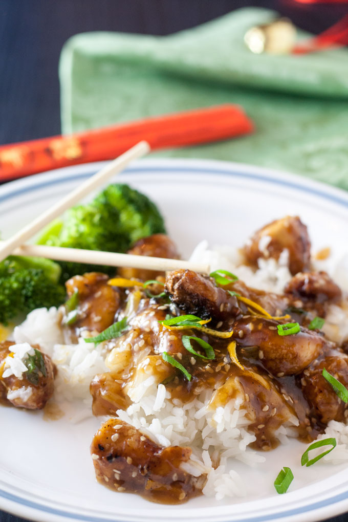 Sesame chicken on rice with chopsticks