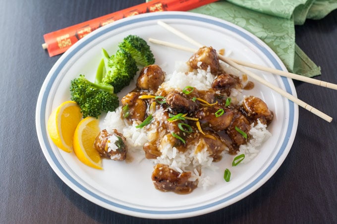 Sesame Orange Chicken stir fry with bowls of rice and broccoli