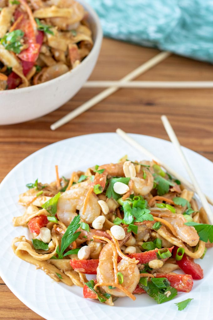 stir fry in large bowl and on white plate