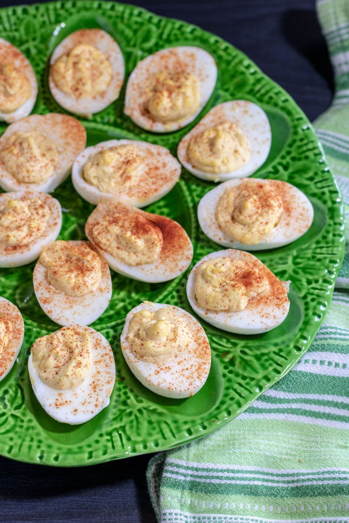 platter of deviled eggs sprinkled with smoked paprika