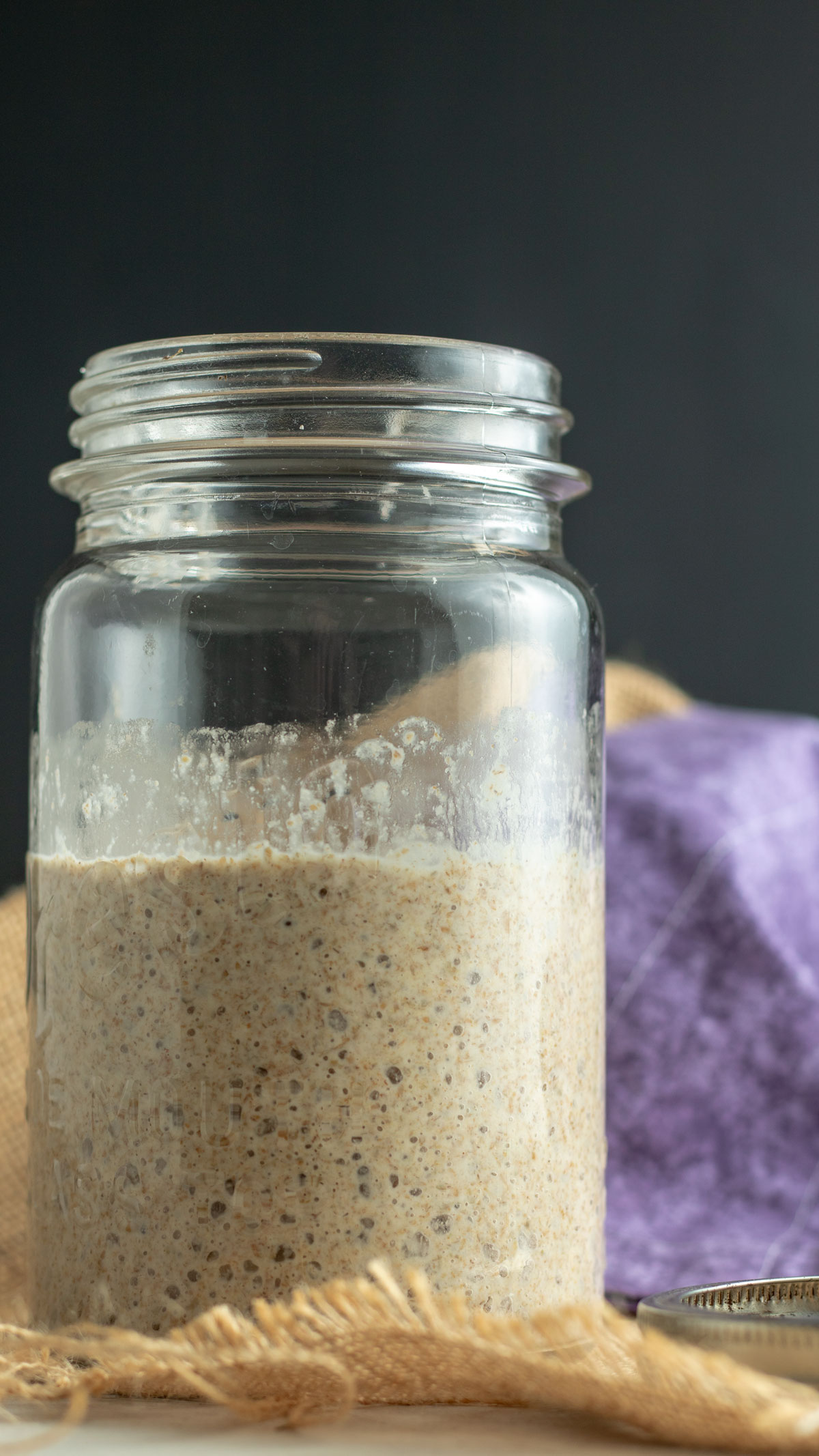 Close up of bubbling jar of starter.