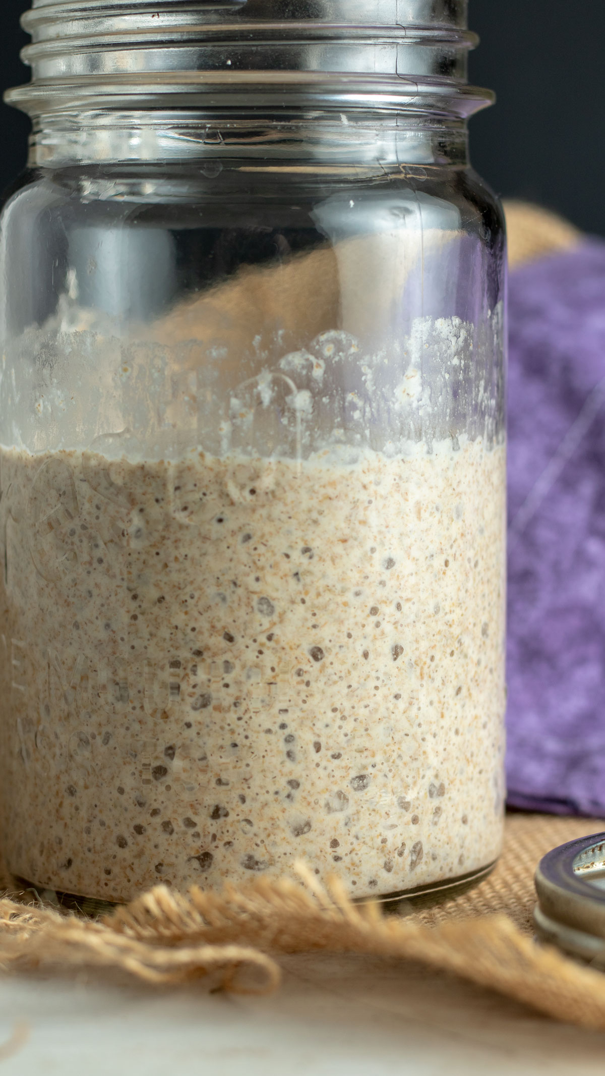 Quart jar with bubbling sourdough starter.