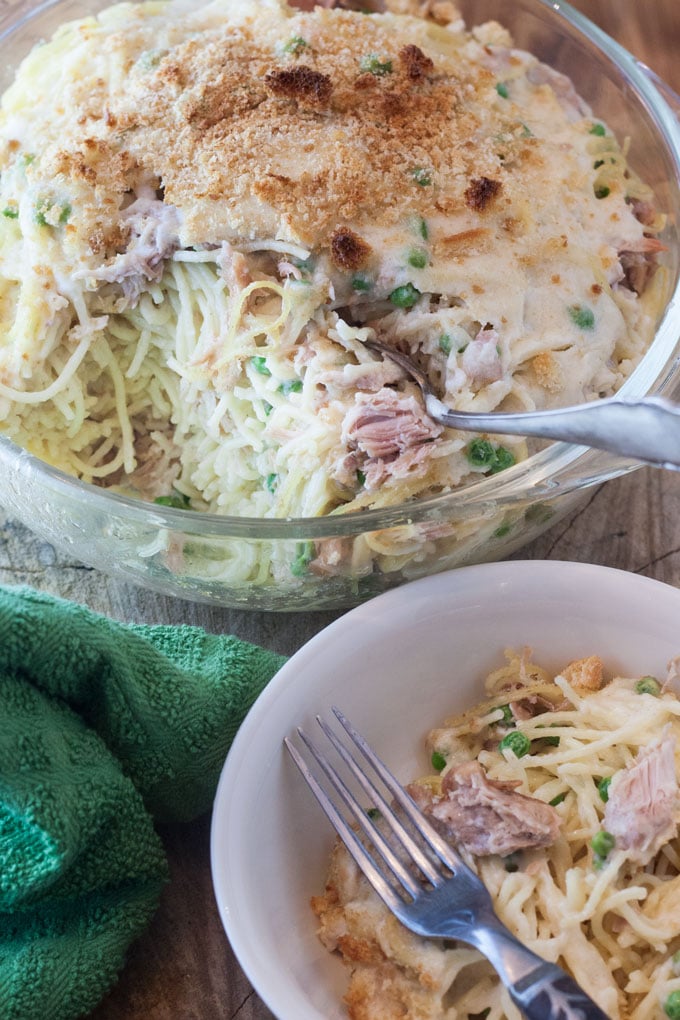spaghetti casserole in clear baking dish with some in white bowl