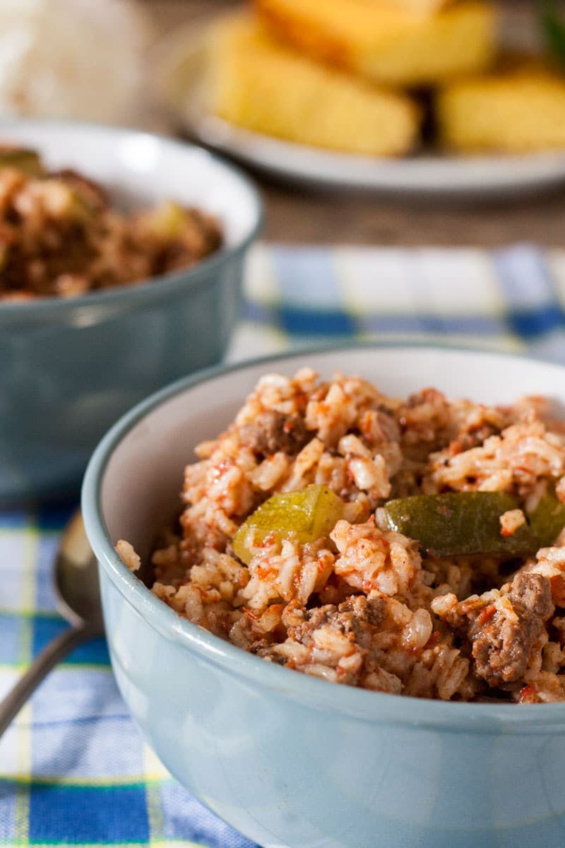 easy spanish rice in gray bowls with cornbread.