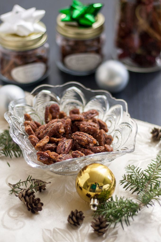 Spicy nuts in glass bowl and packed in decorated canning jars.