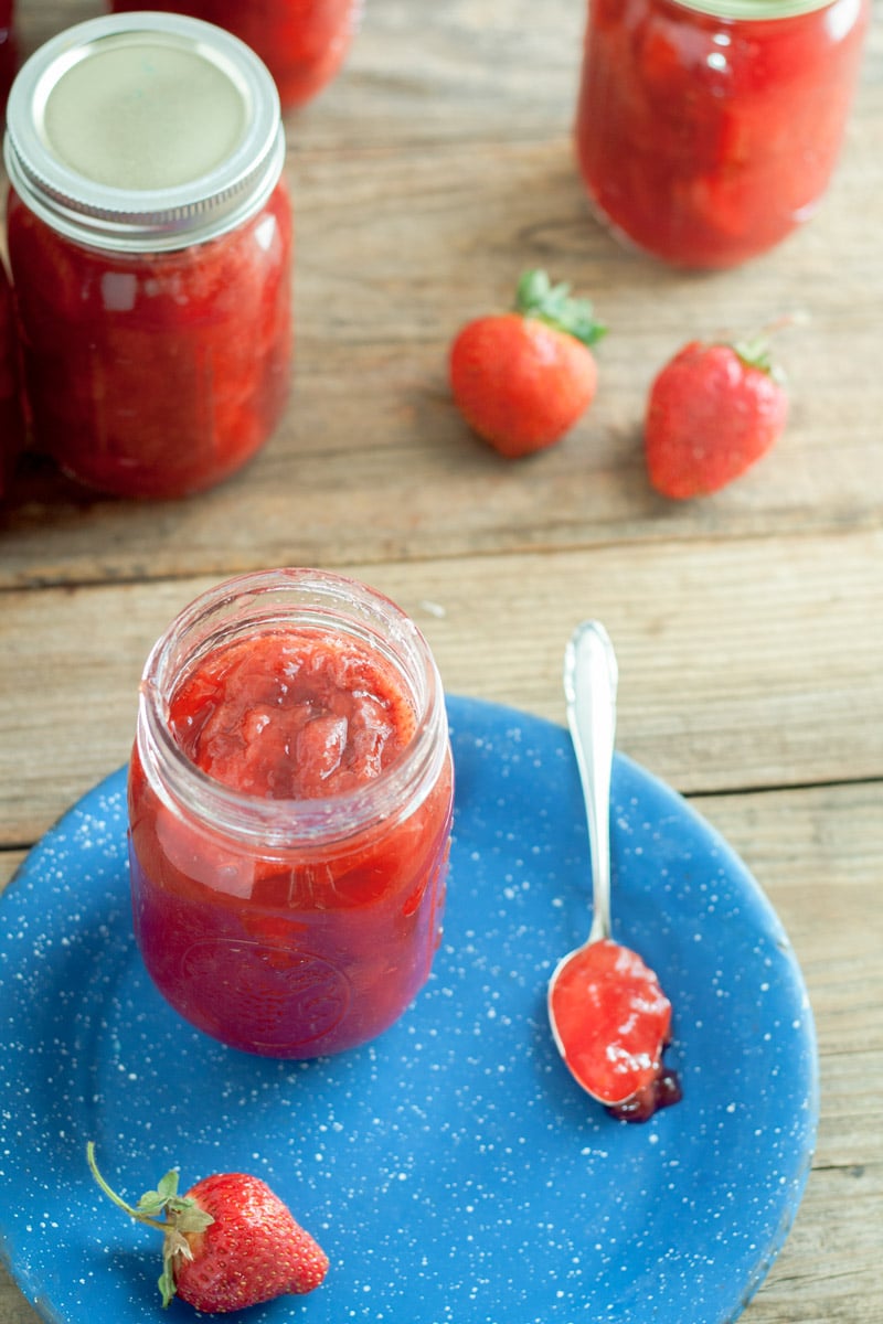 Pint jar of chunky Strawberry Jam on barn wood board