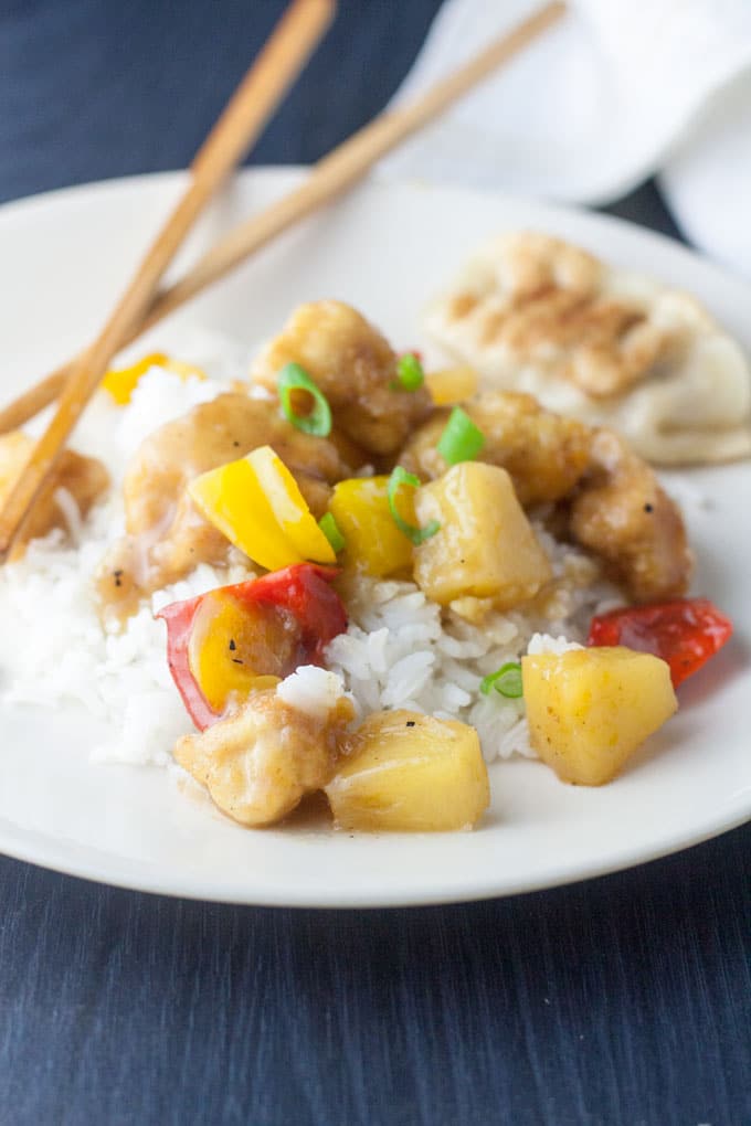 sweet and sour chicken garnished with scallion slices sweet and sour chicken garnished with scallion slices
