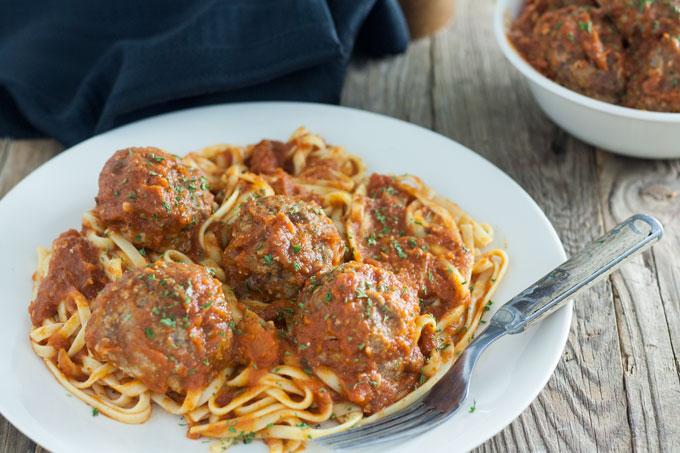 plate of pasta, sauce and meatballs
