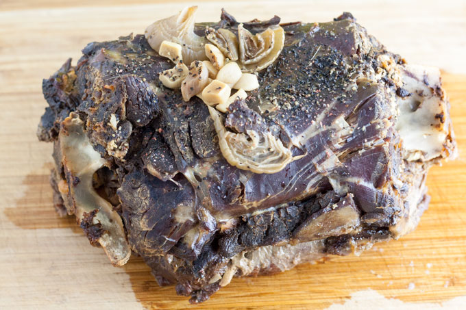 Venison neck roast, after cooking, whole on cutting board