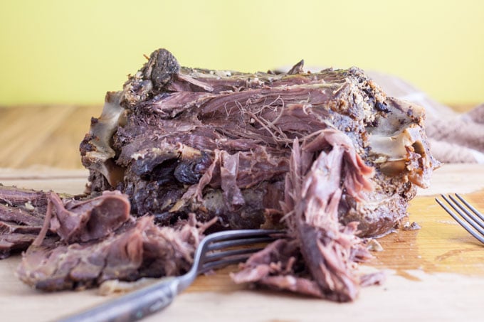some shredded deer with two forks on board for shredding