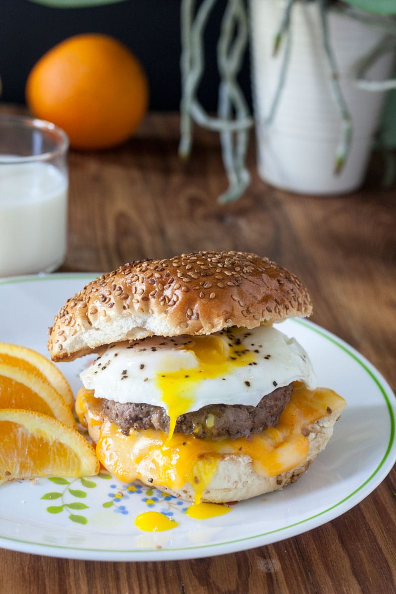 venison breakfast sausage sandwich on a toasted hard roll with top roll added and broken yolk