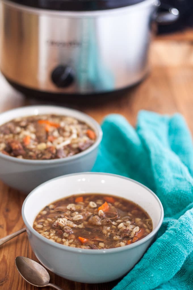 venison soup with green towel and crockpot