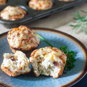 Cheesy herbed bacon muffins on blue plate