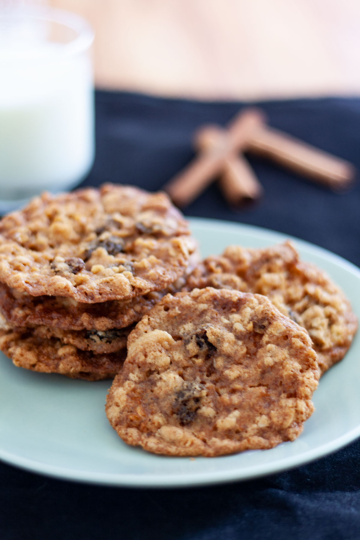 Cookies on white plate with glass of milk.