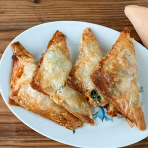 golden brown pastries lined up on plate