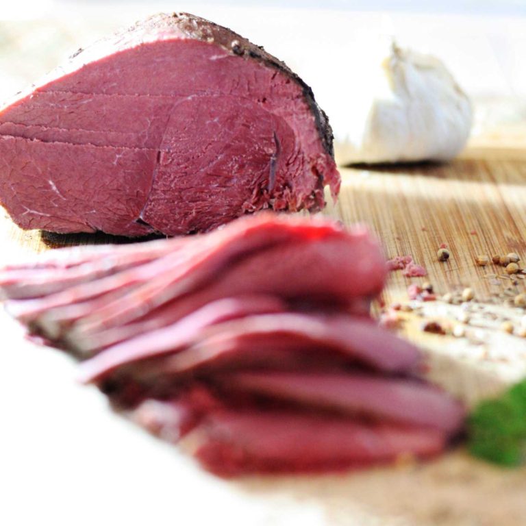 How to Make Home made Corned Venison or Beef - Venison sliced on a bamboo cutting board
