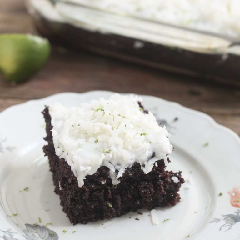 Perfectly Chocolate Chocolate Cake - Very black chocolate cake with white icing topped with shreded coconut and garnished with lime zest