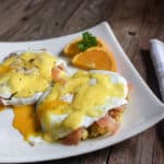 Eggs Benedict with Lox served on Scallion and Curried Rice cakes topped with egg and Hollandaise sauce