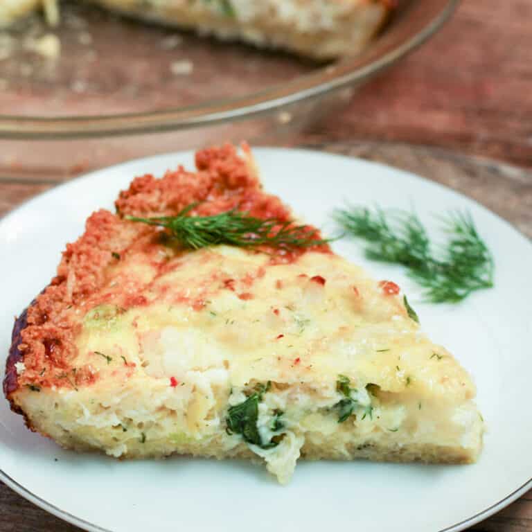 slice of crab and shrimp quiche on white plate
