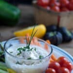 Shrimp Crab Dip for Crudités - Dairy Free - Dip in small, clear glass bowl, garnished with chives on a platter with slice yellow peppers, celery, carrots and cherry tomatoes