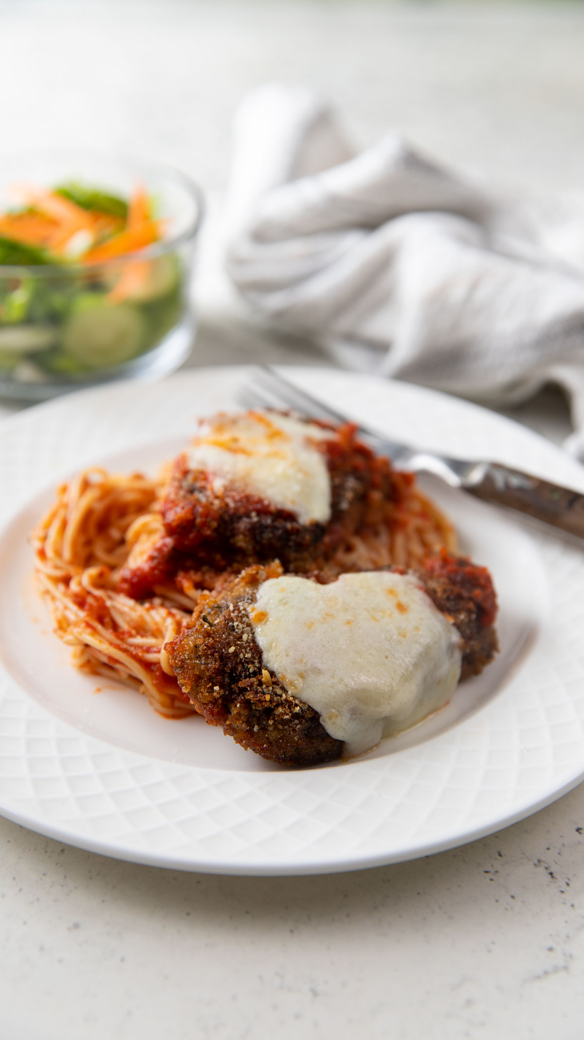 Venison Parmesan on a bed of spaghetti.