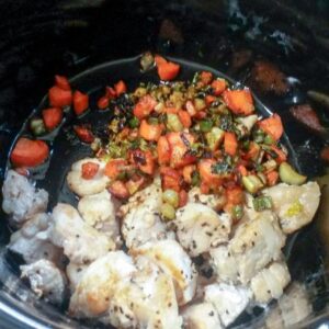 browned alligator meat and vegetables in slow cooker