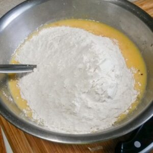 dry ingredients mixing into wet ingredients