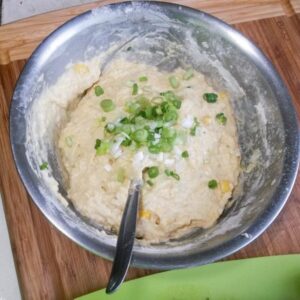 Adding green onion and tabasco to dough
