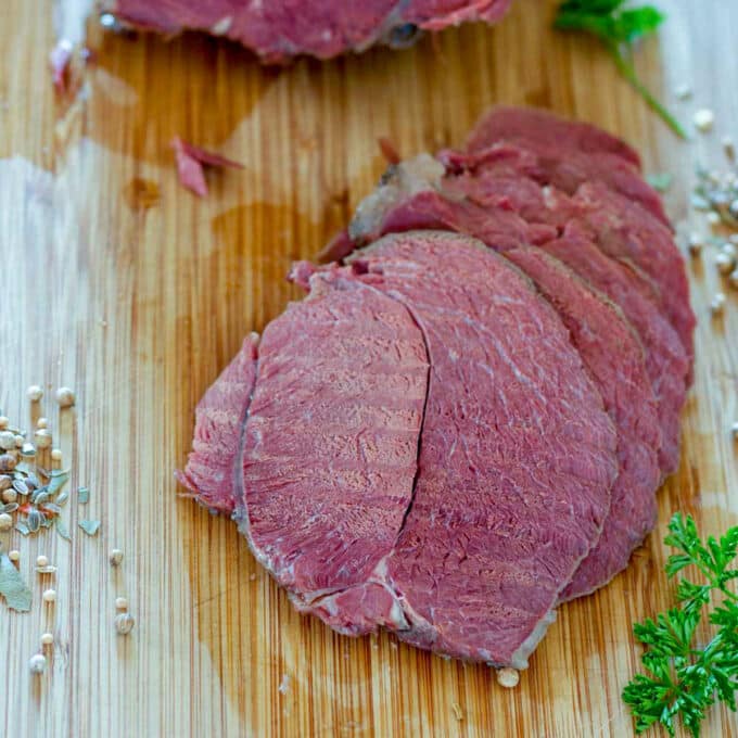 slow cooked corned venison sliced on bamboo board