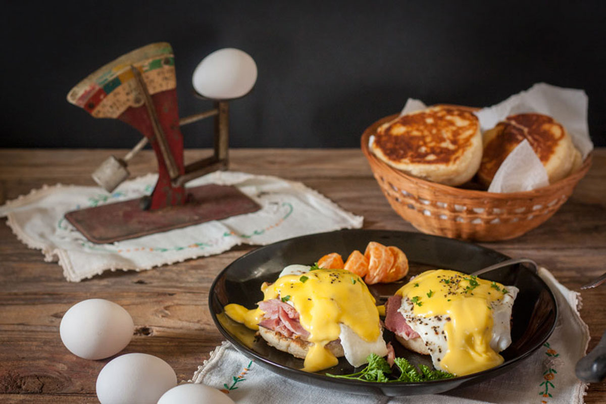 eggs benedict with parsley and orange garnish Eggs benedict with parsley and orange garnish