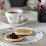 Blueberry Jam on biscuit with antique tea set
