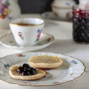 Blueberry Jam on biscuit with antique tea set
