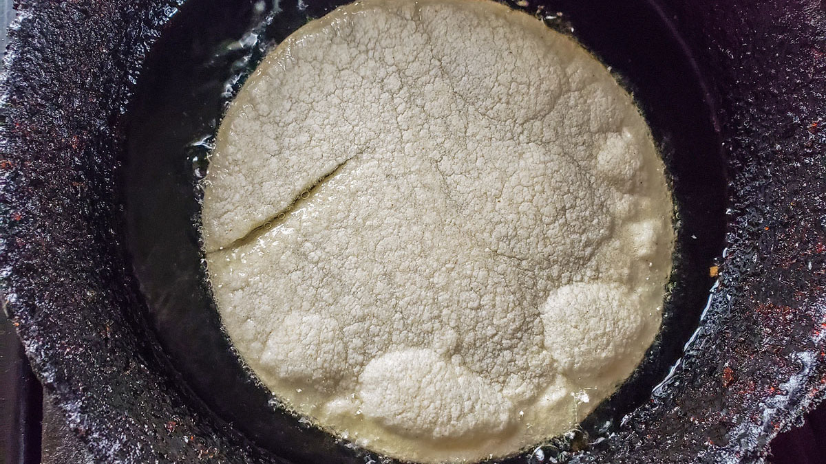 Tortilla in a shallow frying pan with oil.