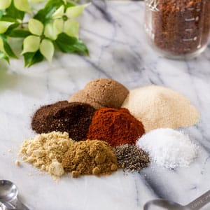 dry rub for pork spices piled on marble board