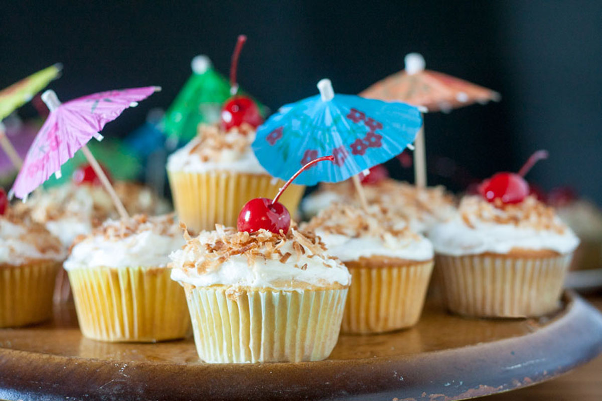 Cupcakes arranged on a pedestal plate in tiers.