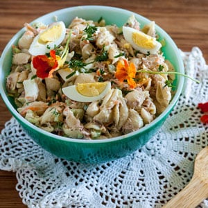 Macaroni salad with tuna garnished with nasturtium flowers