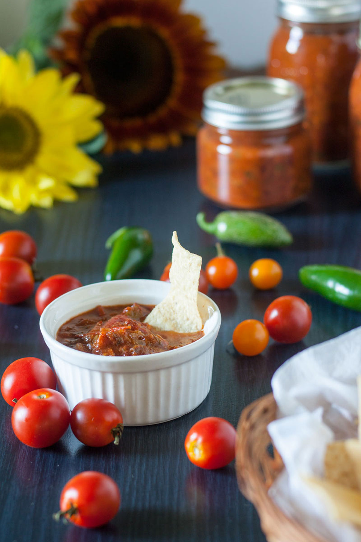 Chipotle salsa in a white ramekin with corn chip.