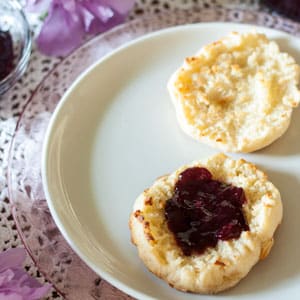 Blackberry jam on English Muffin on white plate