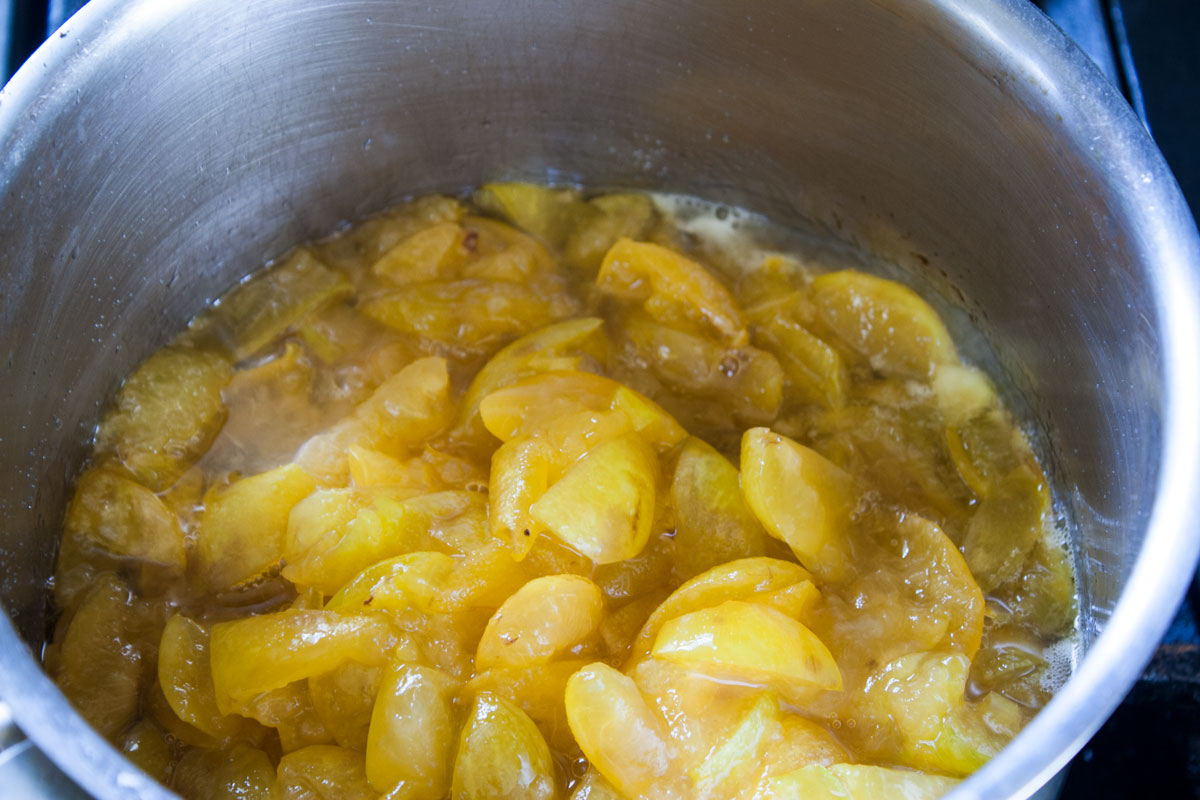 Chopped plums in the sugar water.