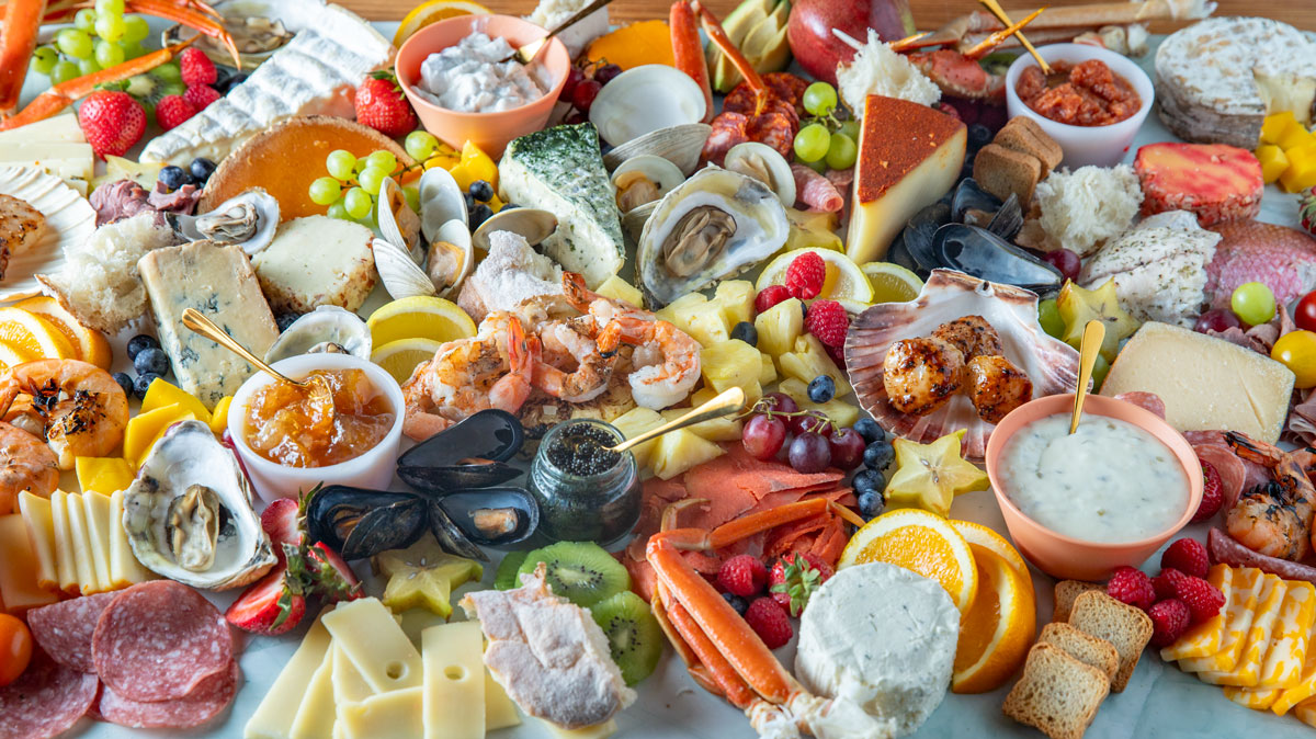 Extremely colorful charcuterie board with seafood.