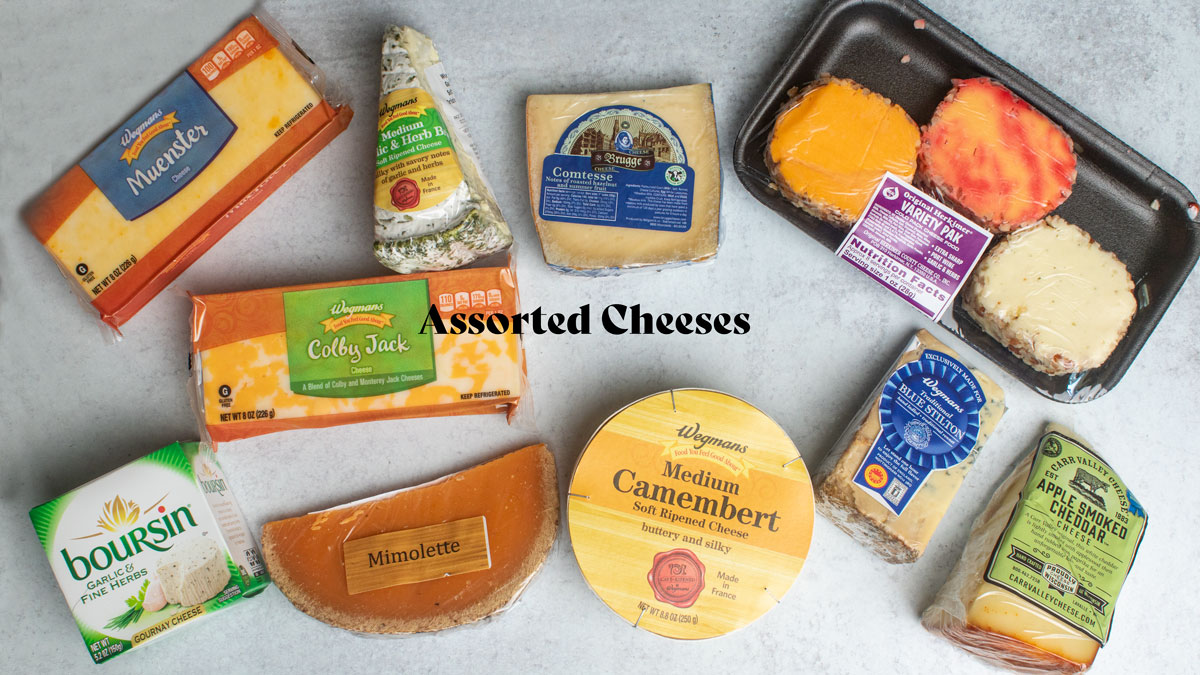 Assorted Cheeses on a white board.